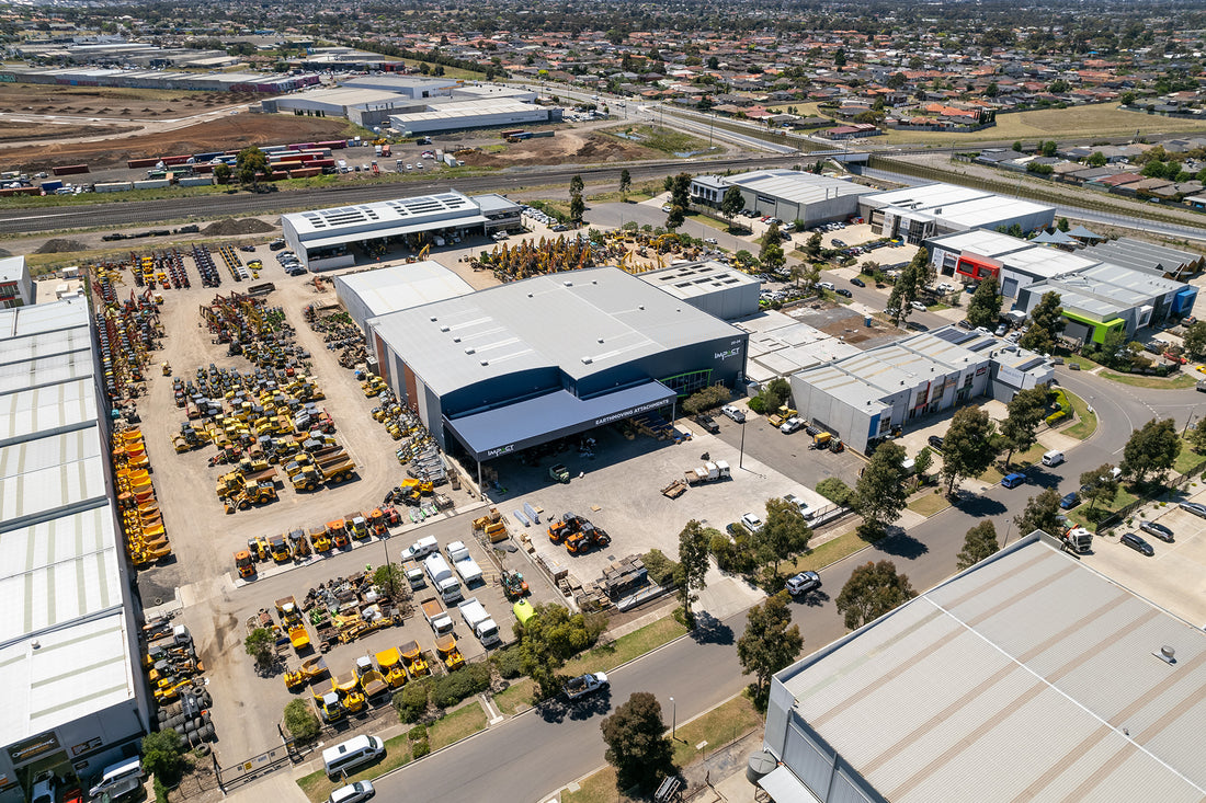 Aerial view of Impact Attachments facility and equipment yard, showcasing a wide range of construction machinery and attachments